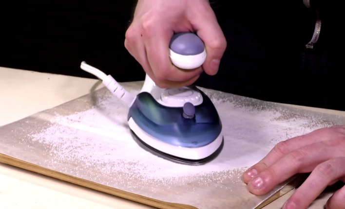 He Sprinkles Salt On Wax Paper, Then Places The Iron On Top. Take Note!
