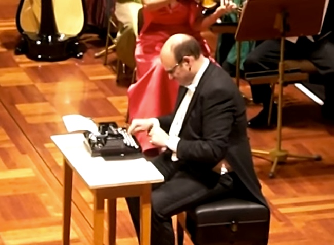 Guy Plays Typewriter With Orchestra